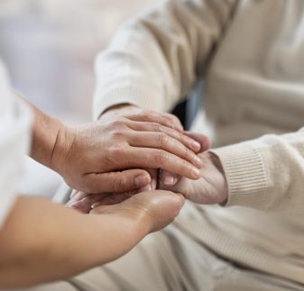 doctor-holding-hands-with-senior-patient
